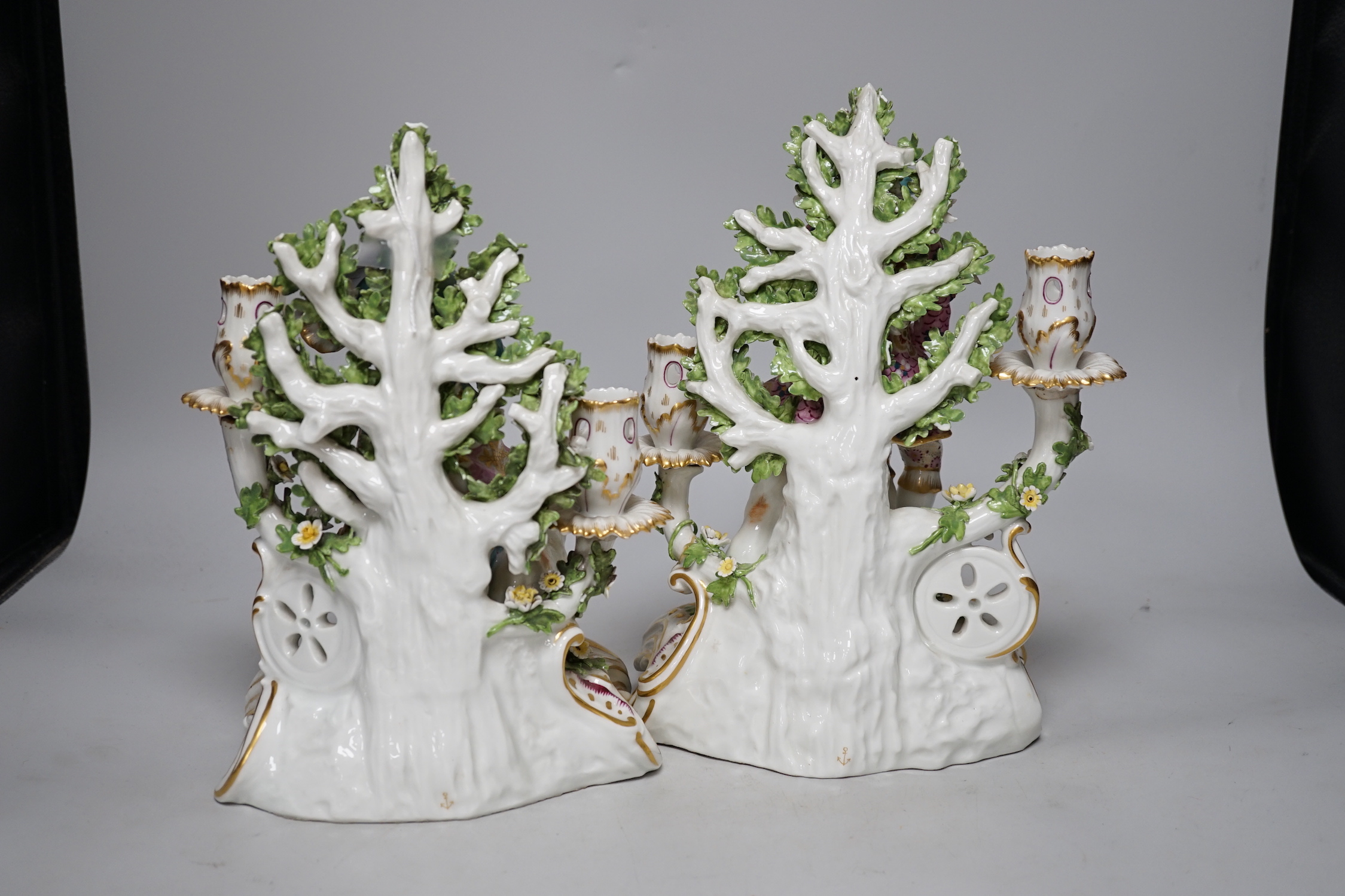 A pair of French porcelain two branch figural candlesticks in the form of musicians, largest 29cm high